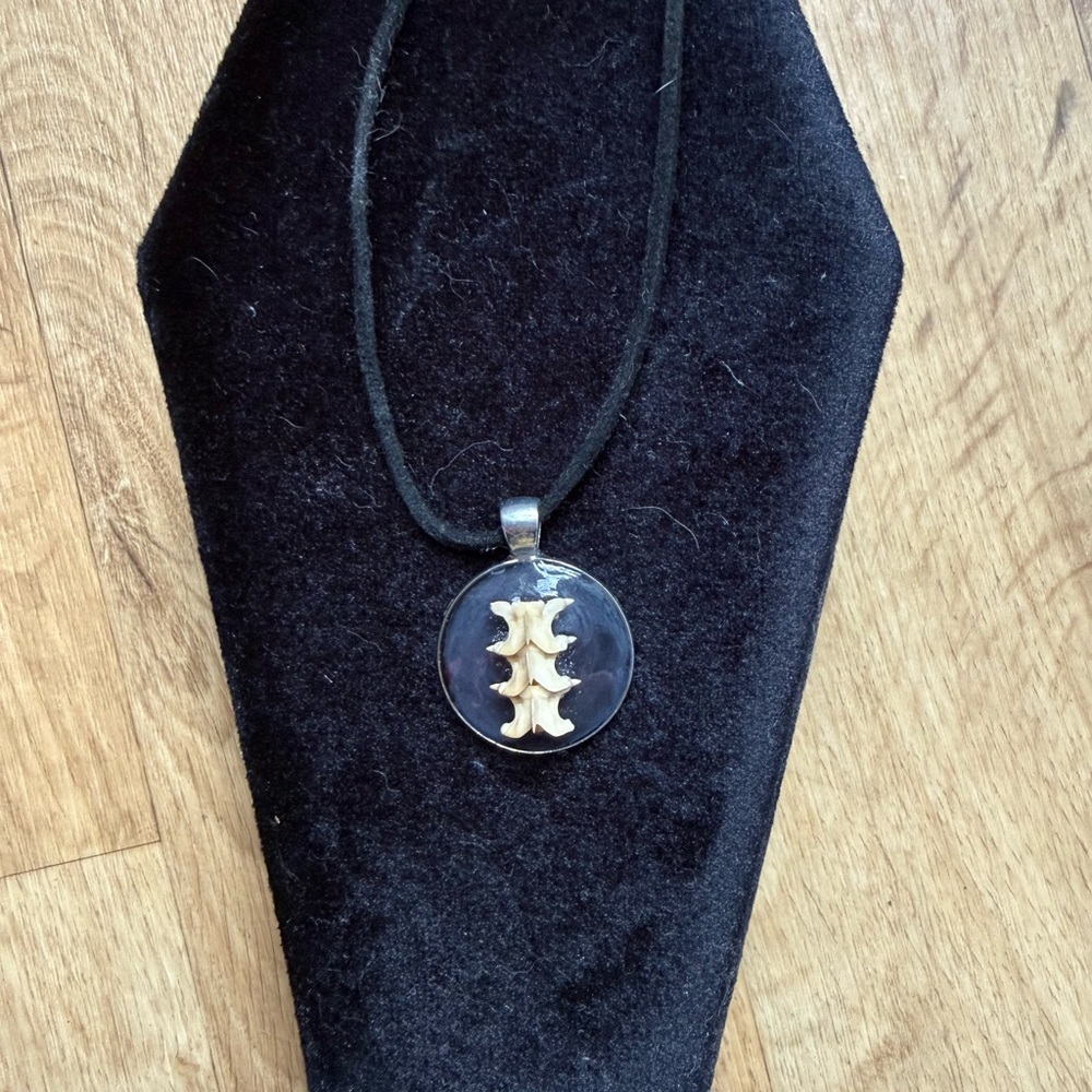 Elegant Gold and Black Pendant Necklace with spinal animal bone